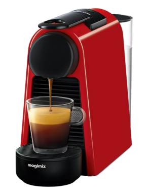 Nespresso Essenza Mini in vibrant red, brewing a fresh espresso into a clear glass cup.