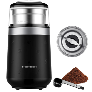 Twomeow Coffee Grinder with finely ground coffee, a transparent lid, sleek black design and steel blades.