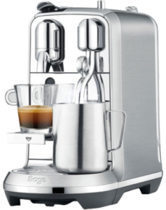Sage Nespresso Creatista Plus, a sleek stainless steel coffee machine brewing fresh espresso into a clear glass cup.