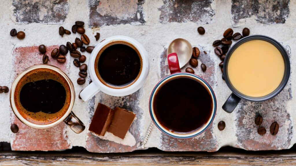 Variety of coffee cup styles showcasing espresso, black coffee, and creamy latte in elegant mugs.